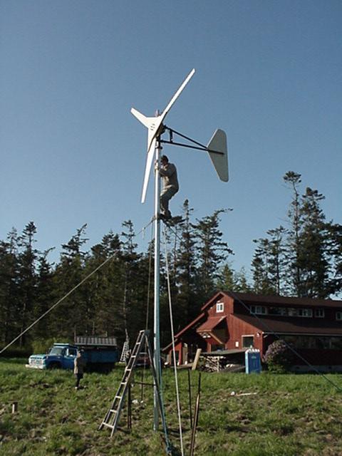Hugh Piggott atop the tower for his new 12 foot dia. wind turbine